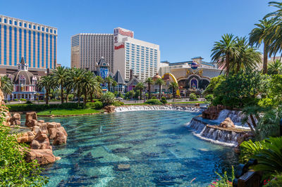 Calm river with buildings in background