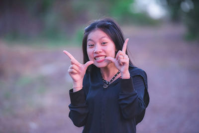 Portrait of smiling woman standing outdoors