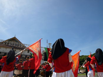 Group of people against sky