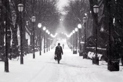 Snow covered road in city at night