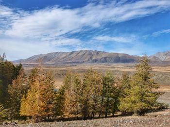 Scenic view of mountains against cloudy sky