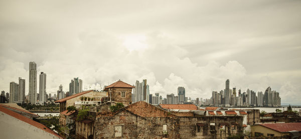 View of buildings in city against sky during sunset