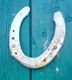 Close-up of metal horseshoe on wooden table