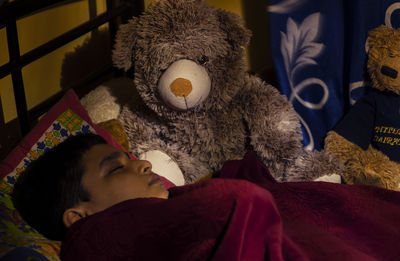 Rear view of stuffed toy on bed at home