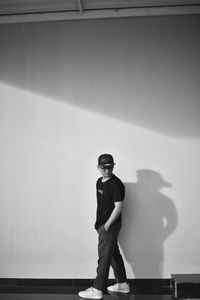 Low angle view of man standing against wall
