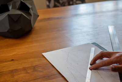 High angle view of human hand on table