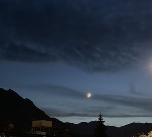 Scenic view of silhouette mountains against sky at night