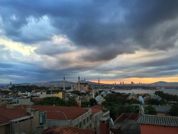 Cityscape against cloudy sky