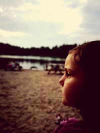 Portrait of girl looking away against sky