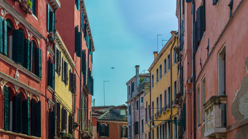 Low angle view of buildings in town against sky