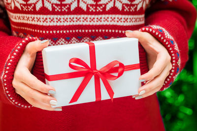 Midsection of woman holding gift box during christmas
