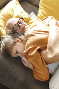 High angle view of girl sleeping on bed at home