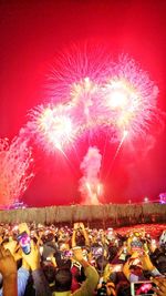 Crowd at music concert against sky at night