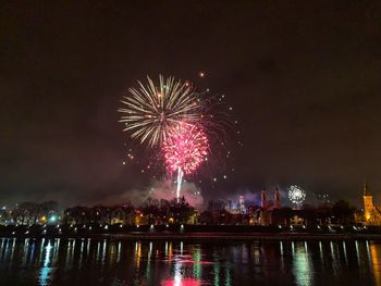 Firework display over city at night