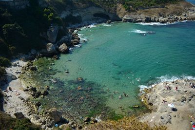 High angle view of sea by cliff