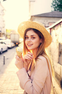 Portrait of a smiling young woman wearing hat