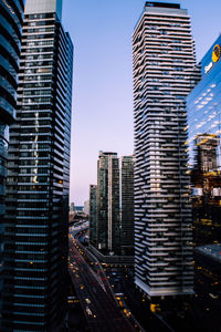 Modern buildings in city against clear sky