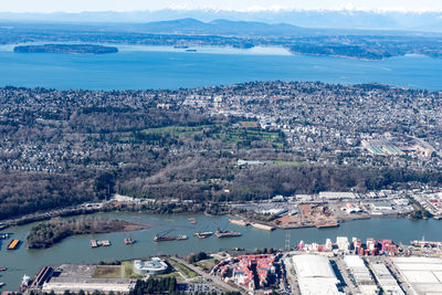 High angle view of sea and cityscape against sky