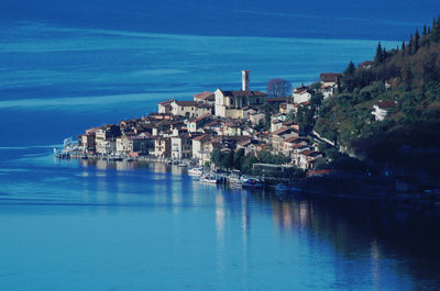 Panoramic view of town by sea against sky