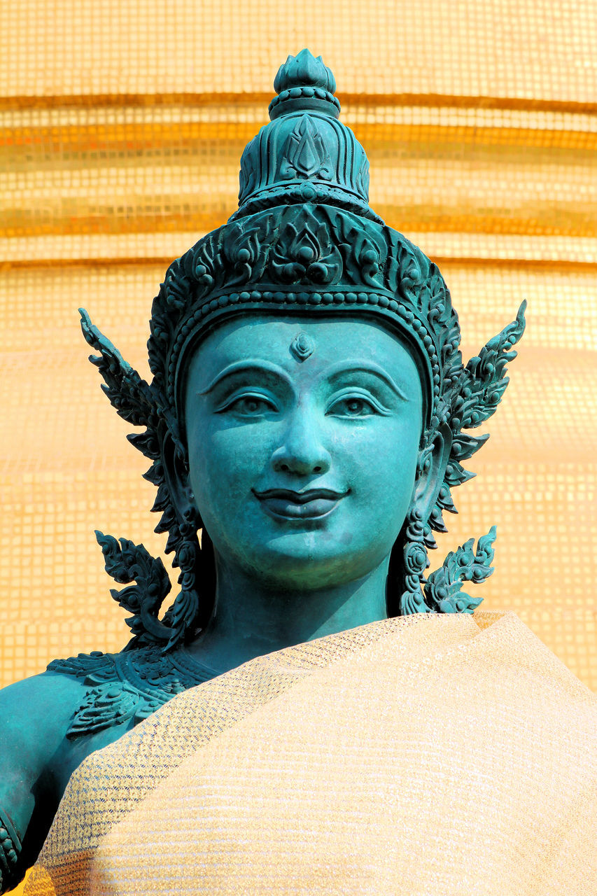 LOW ANGLE VIEW OF STATUE OF BUDDHA AGAINST WALL