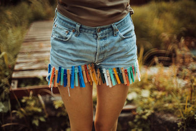 Low section of man standing on multi colored