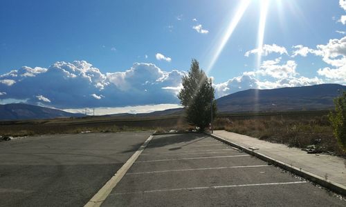 Empty road leading towards mountains