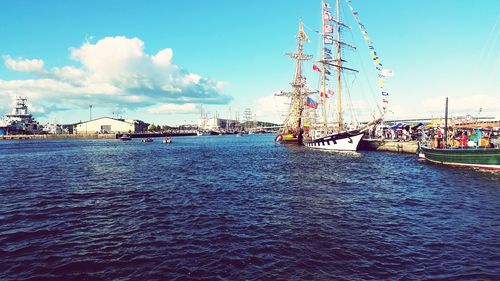 Sailboats in sea against blue sky