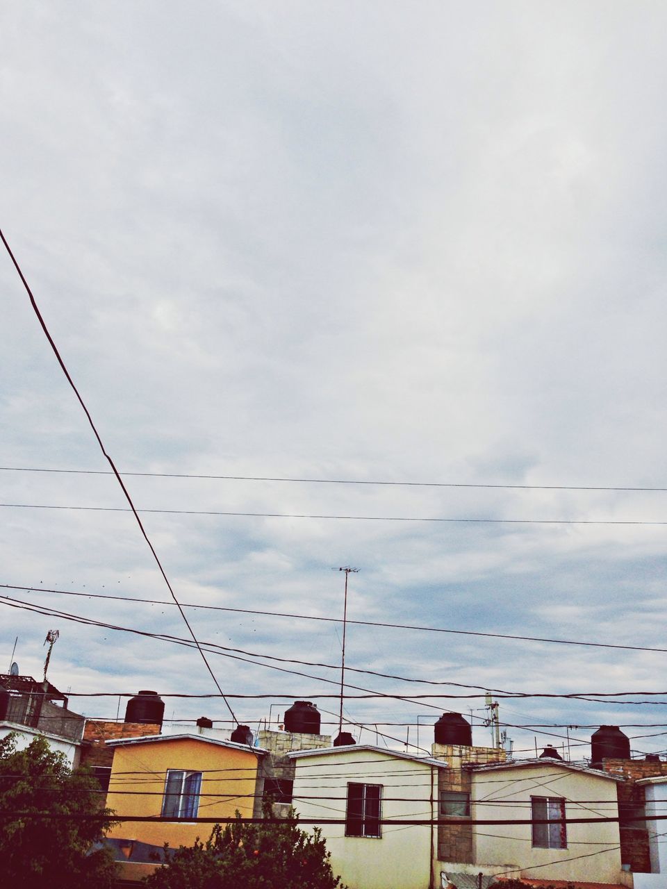 sky, cloud - sky, power line, low angle view, cable, cloudy, electricity pylon, electricity, power supply, cloud, connection, built structure, weather, nature, outdoors, day, no people, building exterior, architecture, fuel and power generation