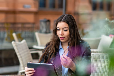 Young woman using mobile phone outdoors