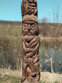 Sculpture on field against sky