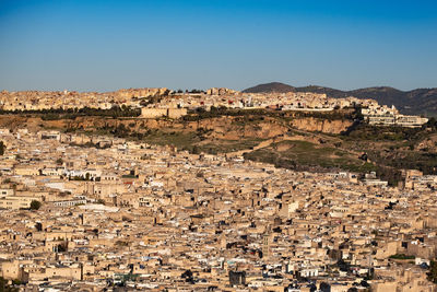 Aerial view of townscape against clear blue sky