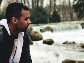 Close-up of young man by river