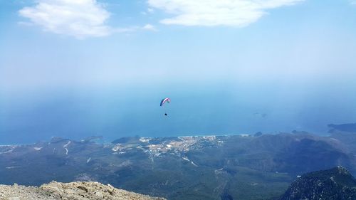 Person paragliding over mountain