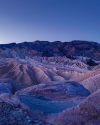 Scenic view of mountains against clear blue sky