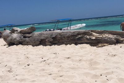 Scenic view of beach against clear blue sky