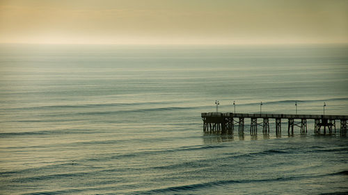Pier over sea against sky
