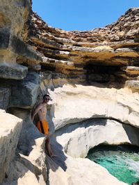 Woman sitting on rock