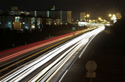 High angle view of light trails on city street at night