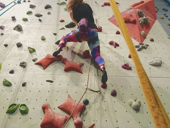 Low angle view of woman doing rock climbing