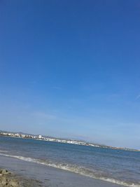 Scenic view of sea against blue sky