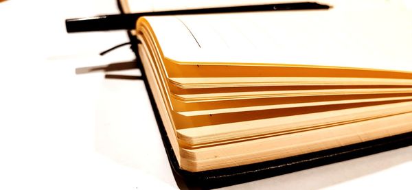Close-up of empty seats on table against white background