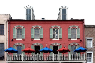 Red building against sky in city