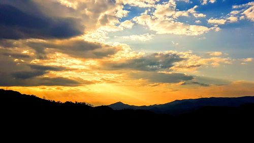 Scenic view of silhouette mountains against sky during sunset