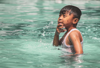 Portrait of young woman swimming in lake