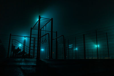 Low angle view of illuminated building against sky at night
