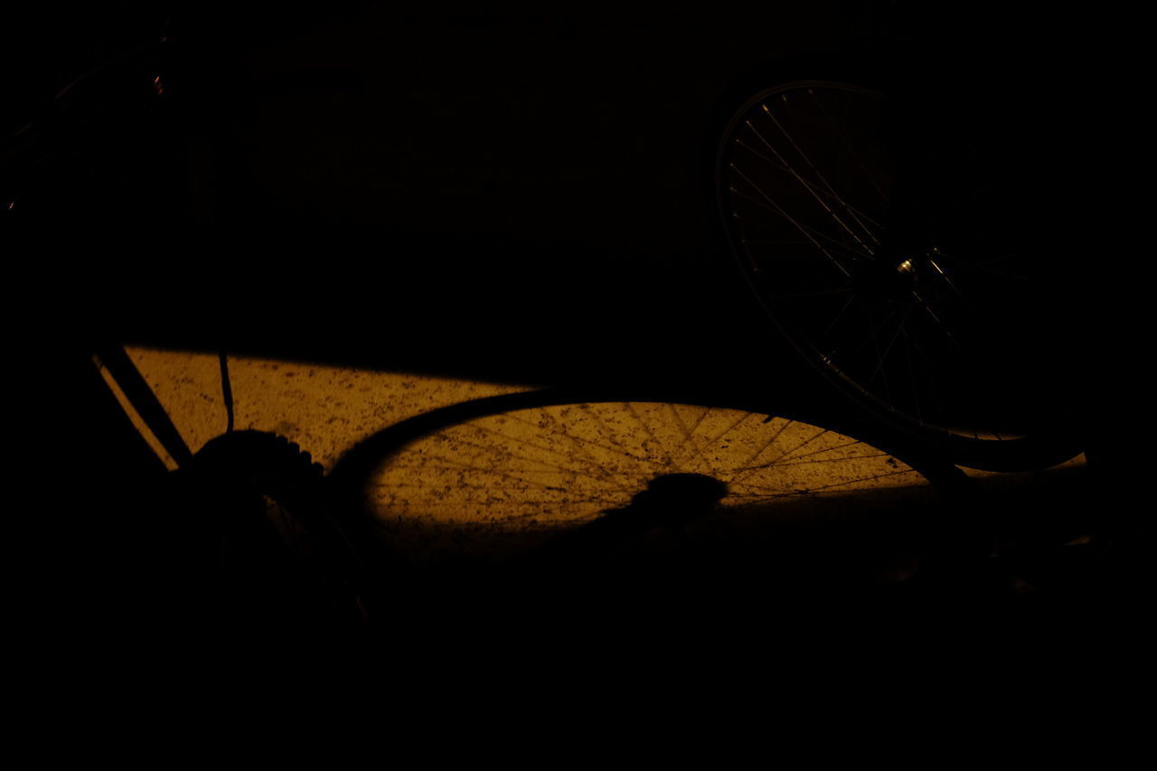 HIGH ANGLE VIEW OF SILHOUETTE BICYCLE IN NIGHT