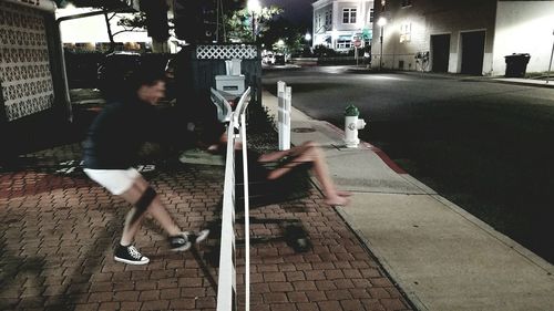 People walking on sidewalk in city