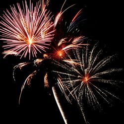 Low angle view of firework display at night