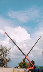 Low angle view of crane against sky