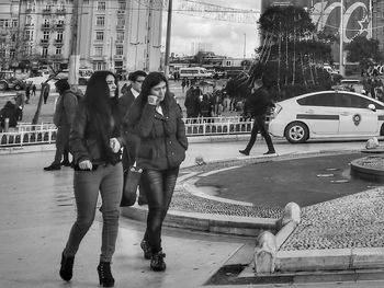 People walking on road in city